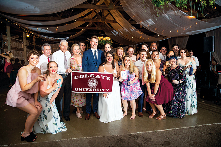 wedding party with Colgate banner