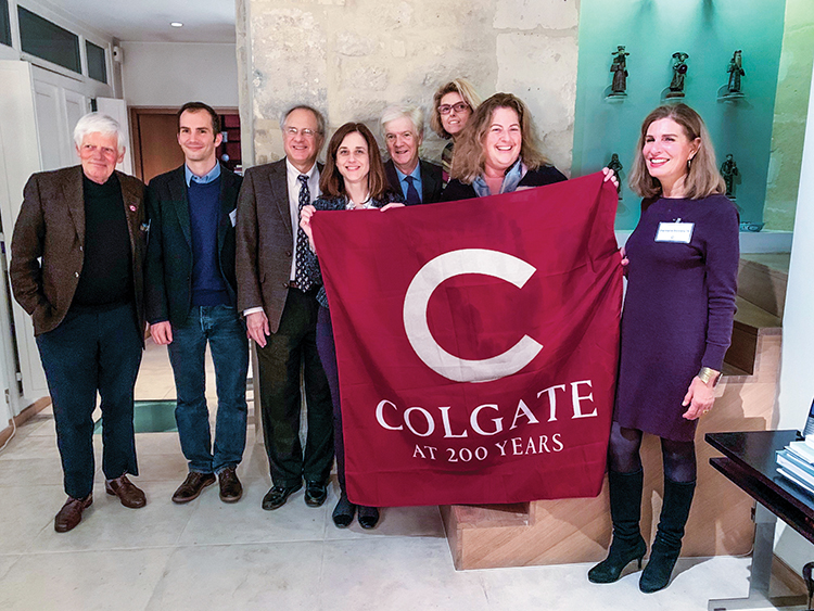 group holding a Colgate banner