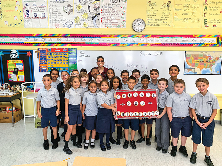 Fourth grade class holding up sign saying Colgate University 200
