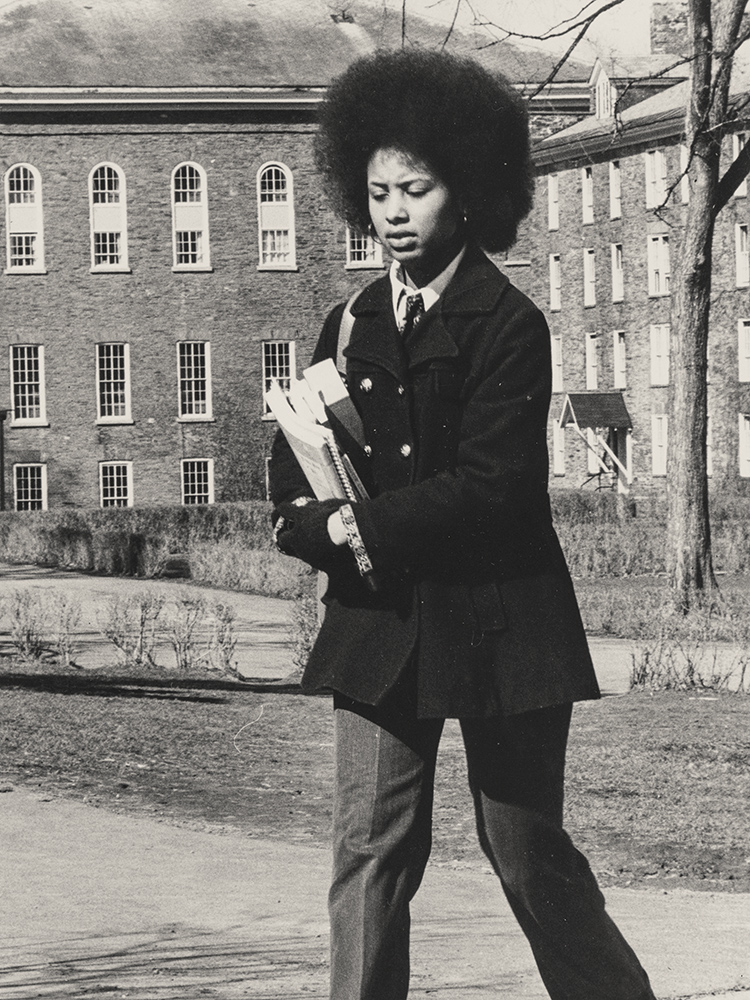Female student carrying books on campus