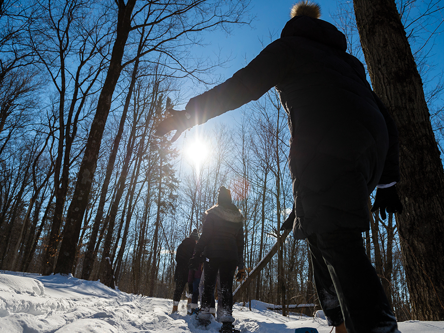students snow shoeing on snowy trails