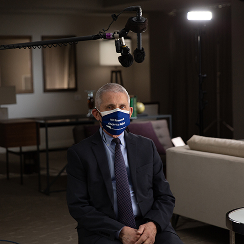 Dr. Anthony Fauci being interviewed on a set with a microphone cantilevered above his head