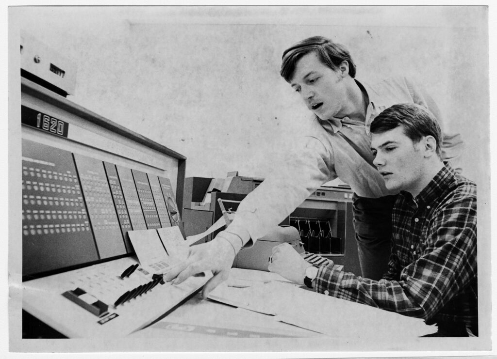 Students working on a computer in the late 1960's.