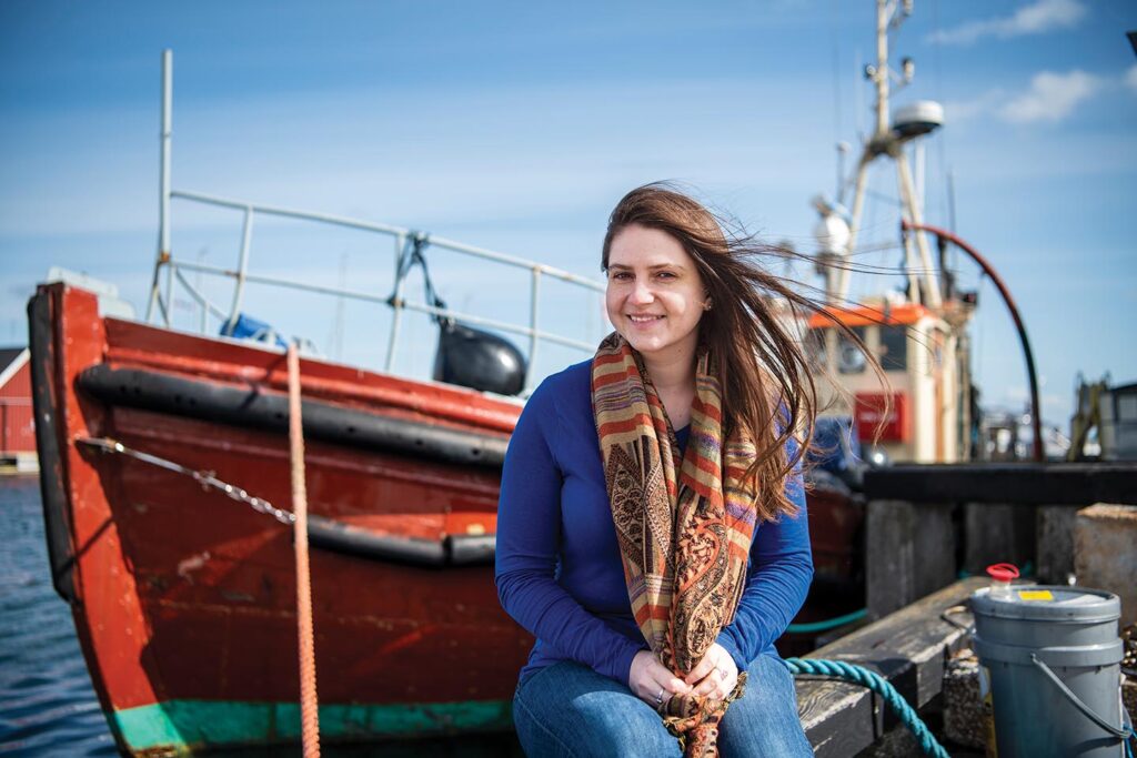 Christine Herbert sitting on a fishing boat