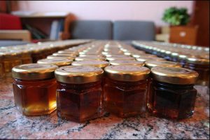 A collection of glass jars of maple syrup