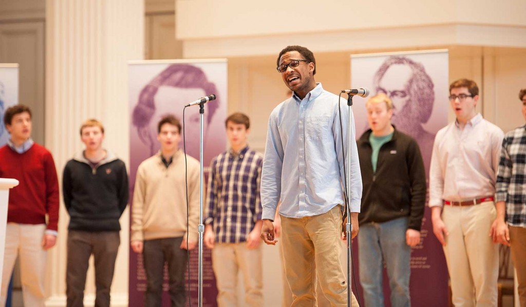 Students singing onstage in the Colgate Memorial Chapel