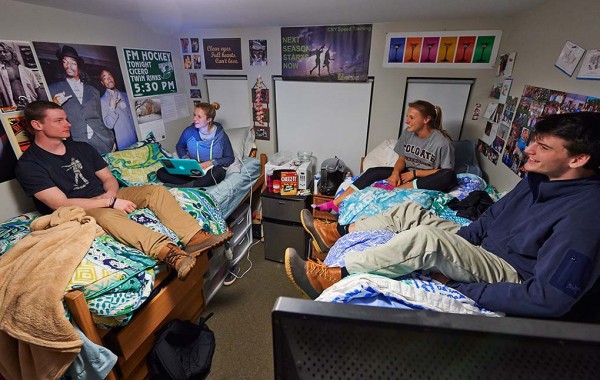 Students sitting on beds, talking, in Curtis Hall