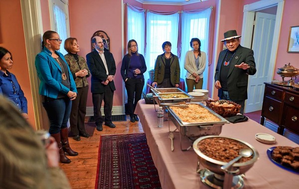 Faculty and students gather as Dennis Banks blesses a meal