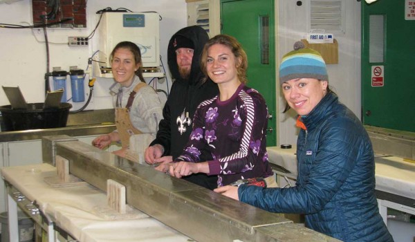 Four students busy at a workbench