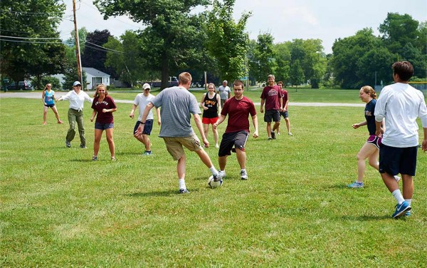 Chemistry professors and students play soccer.