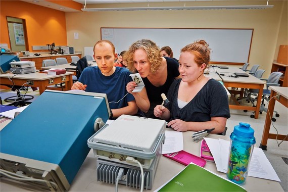 Professor Beth Parks works with students in a frequencies lab
