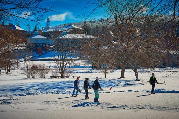 Students play hockey on a frozen Taylor Lake
