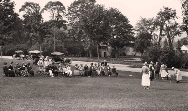 Archival photo of spectators watching others golf