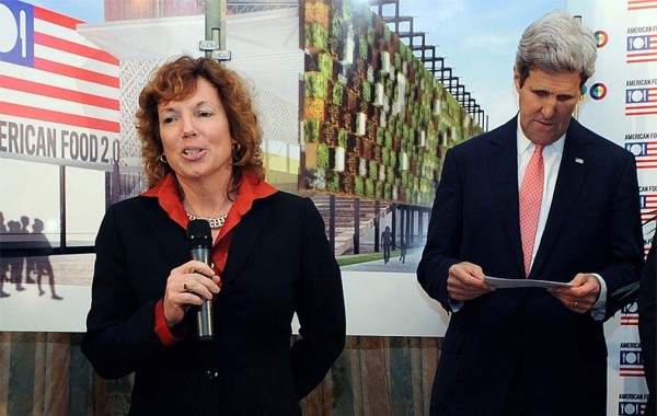 Kathleen Doherty ’85 speaks next to Secretary of State John Kerry
