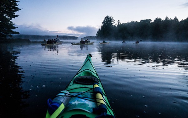 Students kayak through the morning mist on Cranberry Lake in the Adirondacks