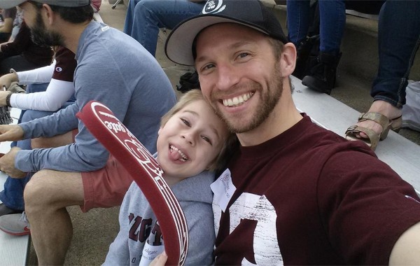 Devon Skerritt ’00 and his 5-year-old son, Cullen in the stands
