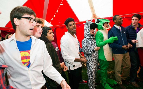 The Colgate Thirteen sing a capella in costumes at a Halloween tailgate