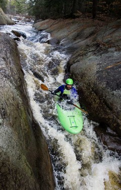 Student kayaks through rapids