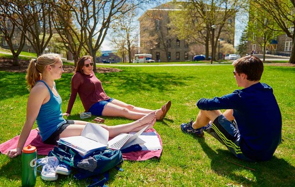 Chloe Weiss ’18, MaryKathryn McCann ’18, and Brendan Corrodi ’18 take a study sunshine break on the residential quad.