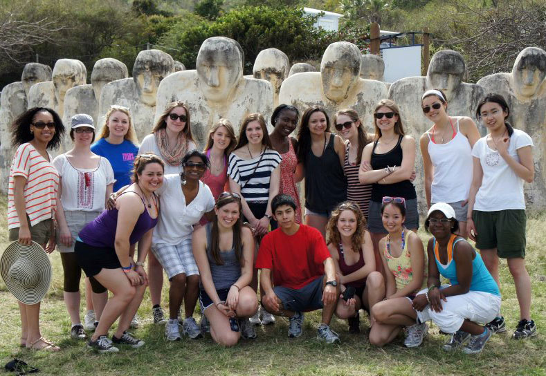 Student group photo with statues in Martinique