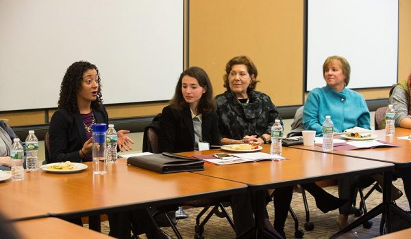 Women in Law participants speak at a gathering on campus