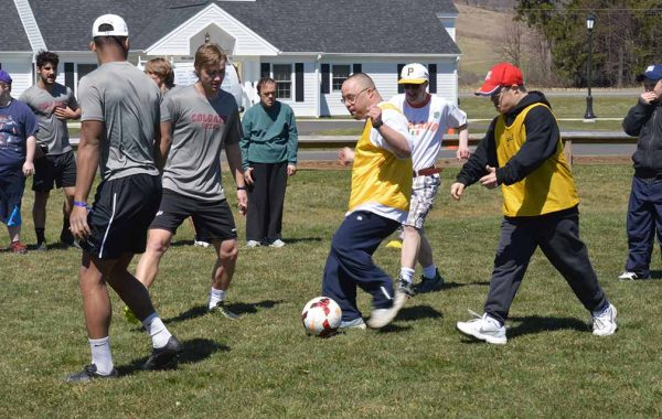 Colgate soccer players work on drills with residents of Pathfinder Village
