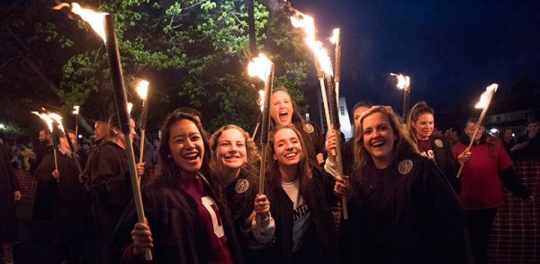 Students carrying torches for the ceremony