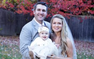 Wedding photo of Crystal and Evan with their daughter.