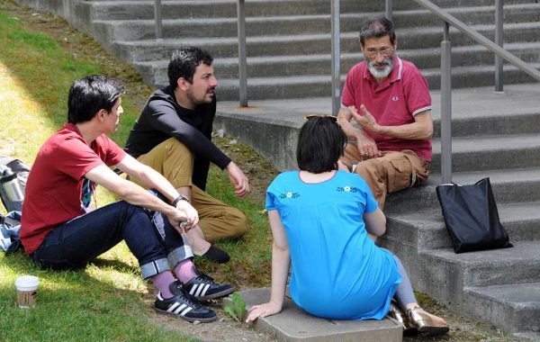 Group of four sitting on Persson steps having a discussion