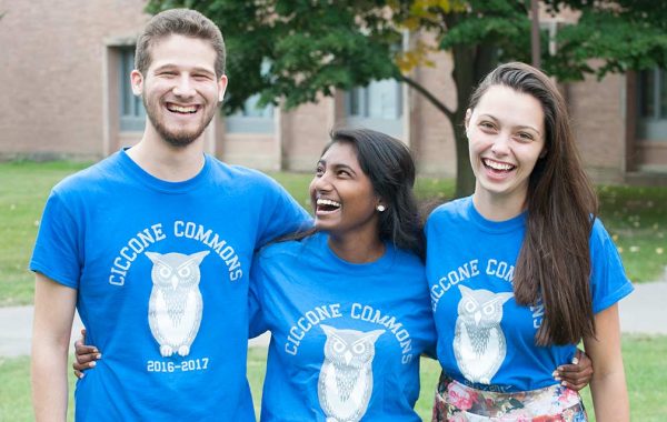 Three students in Ciccone Commons shirts with owls on them