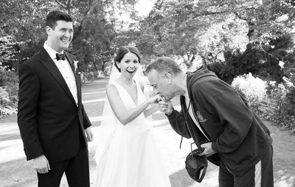 Tom Hanks kisses the hand of Elisabeth Murphy ’11 while her new husband Ryan Barclay smiles in astonishment