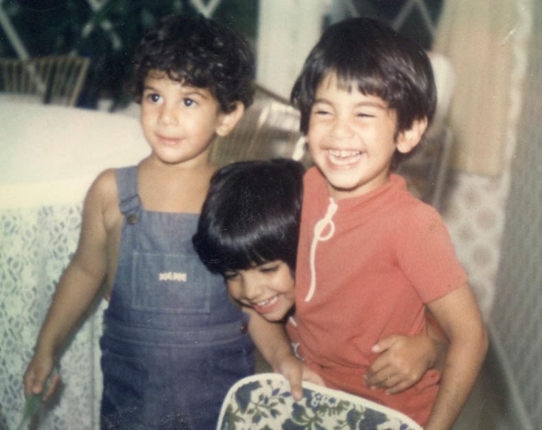 Chris and his siblings smiling for the camera as young children