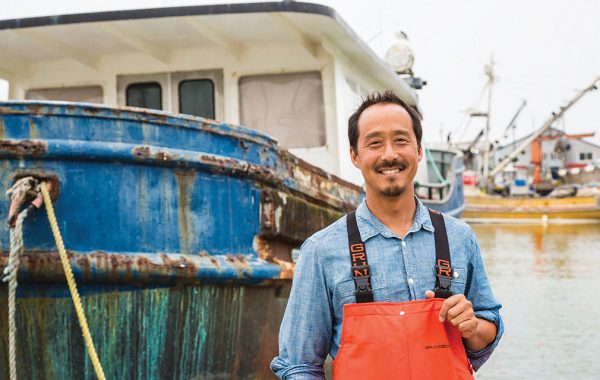 Chris Wang ’94 in front of his fishing boat