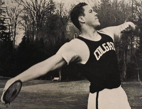 Busch throwing the discus in a Colgate jersey on campus in 1963