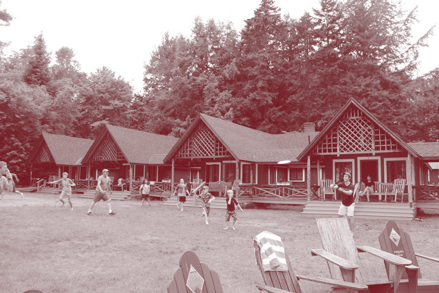 Children and adults playing on the lawn of Colgate Camp
