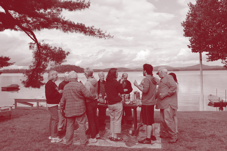 Adult campers share a snack on the lawn of Colgate Camp