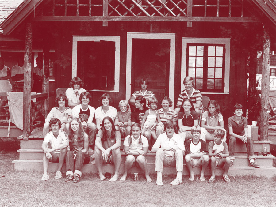 Archival photo of a group on the steps at Colgate Camp.