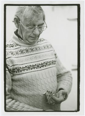 Black and white photo of Roger Alan Hoffman holding a rodent