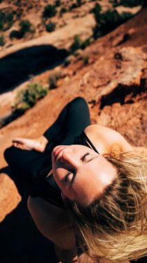 A woman meditating in canyon