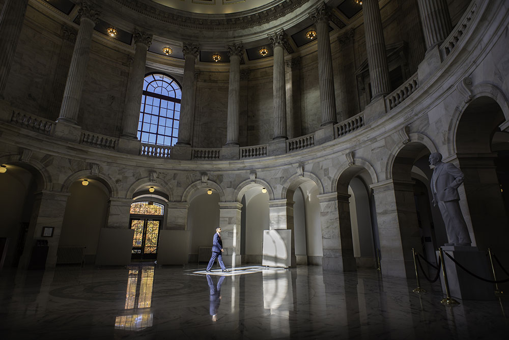 Franco Brunet strides across the Rotunda in the Russell Building.