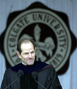Eliot Spitzer at the commencement podium with the Colgate seal in the background