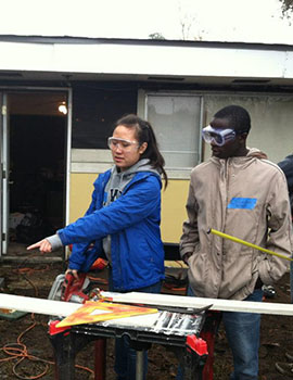 Students in New Orleans help repair a home damaged in Hurricane Isaac