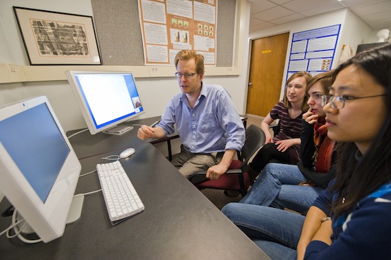 In psychology professor Spencer Kelly's cognitive neuroscience lab, students examine data results from experiments to see how the brain responds to gestures. Professor Kelly is on the far left in the blue shirt.