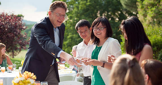 President Jeffrey Herbst hands out his business card to visiting students from Xiamen University. 