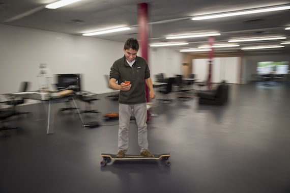 Harry Raymond, founder and CEO of Shindig, which is an on-line app to explore beers, wines and spirits, skateboards through the Colgate University Thought Into Action Incubator, located on Utica Street in downtown Hamilton, NY.