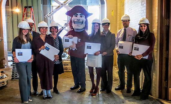 Members of the Colgate Office of Admission, and Raider, pose with the ED acceptance letters on December 13. 