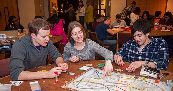Students playing board games at an event held by The Game's Afoot