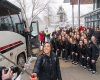 Player Olivia Zafuto uses a selfie stick to take a team picture in front of the team bus