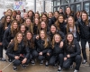 A team picture of the women's ice hockey team as before they board the team bus, bound for the Frozen Four