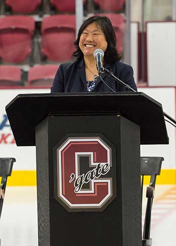 Victoria Chun ’91, MA’94 stands at podium in Class of 1965 Arena